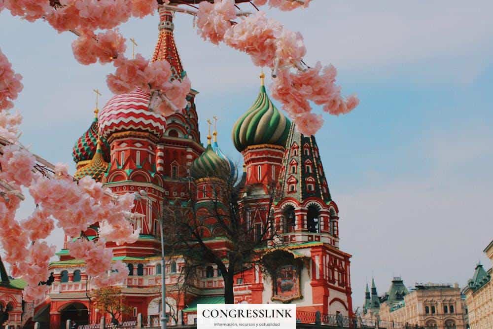 Saint Basil's Cathedral in Moscow framed by cherry blossoms, showcasing vibrant Russian architecture.